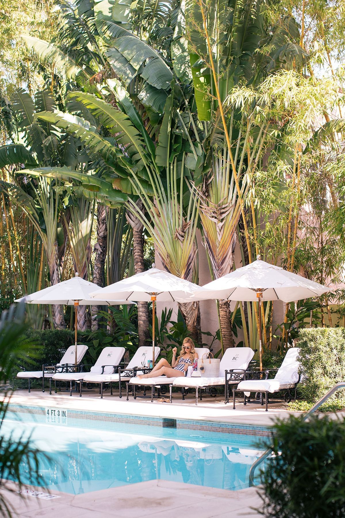 A girl lying on a lounger near the  pool at Brazilian Court