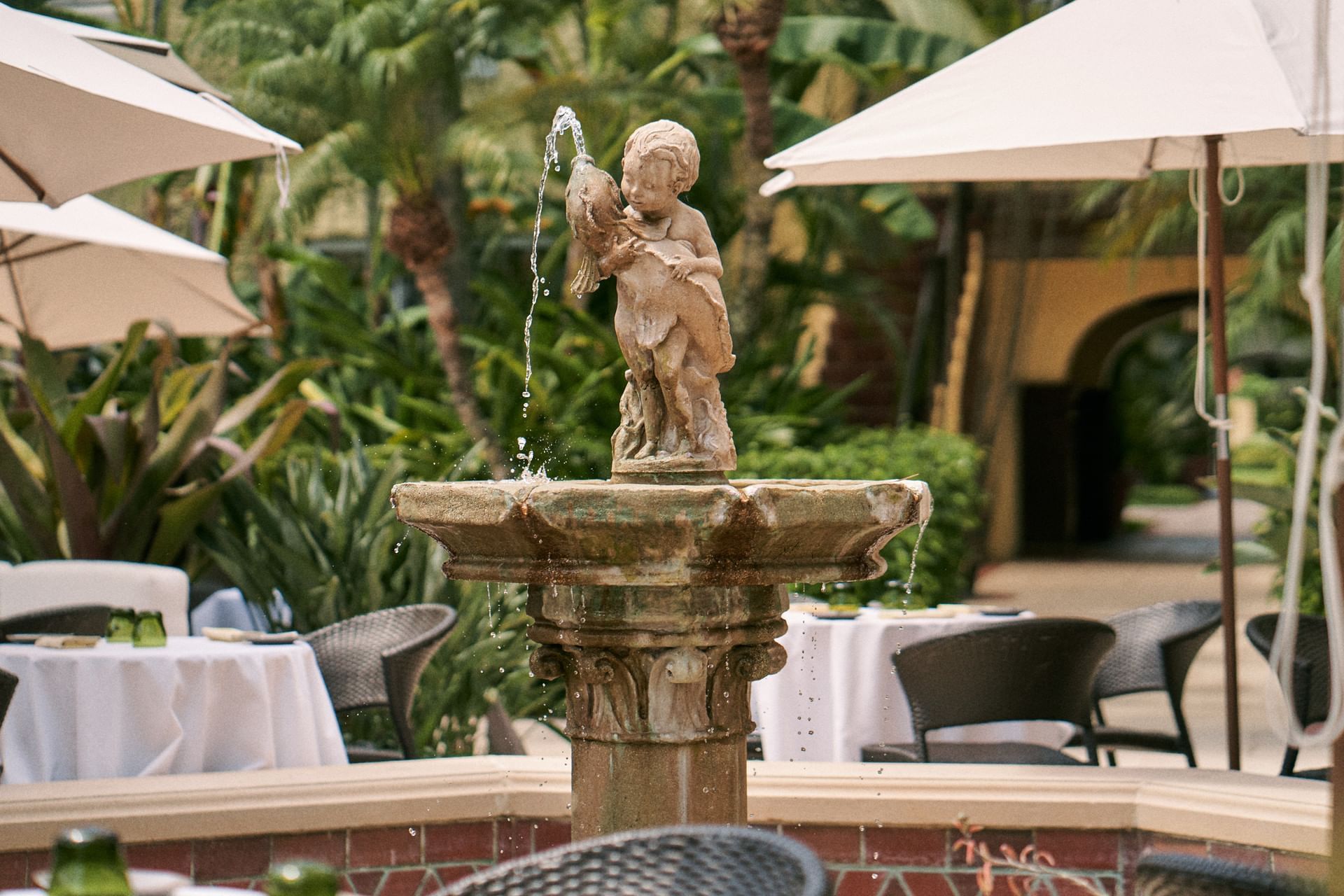 A closeup of Cupid Boy And Fish Fountain at Brazilian Court