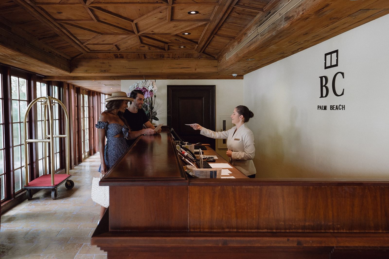 One couple talking with a receptionist at Brazilian Cour